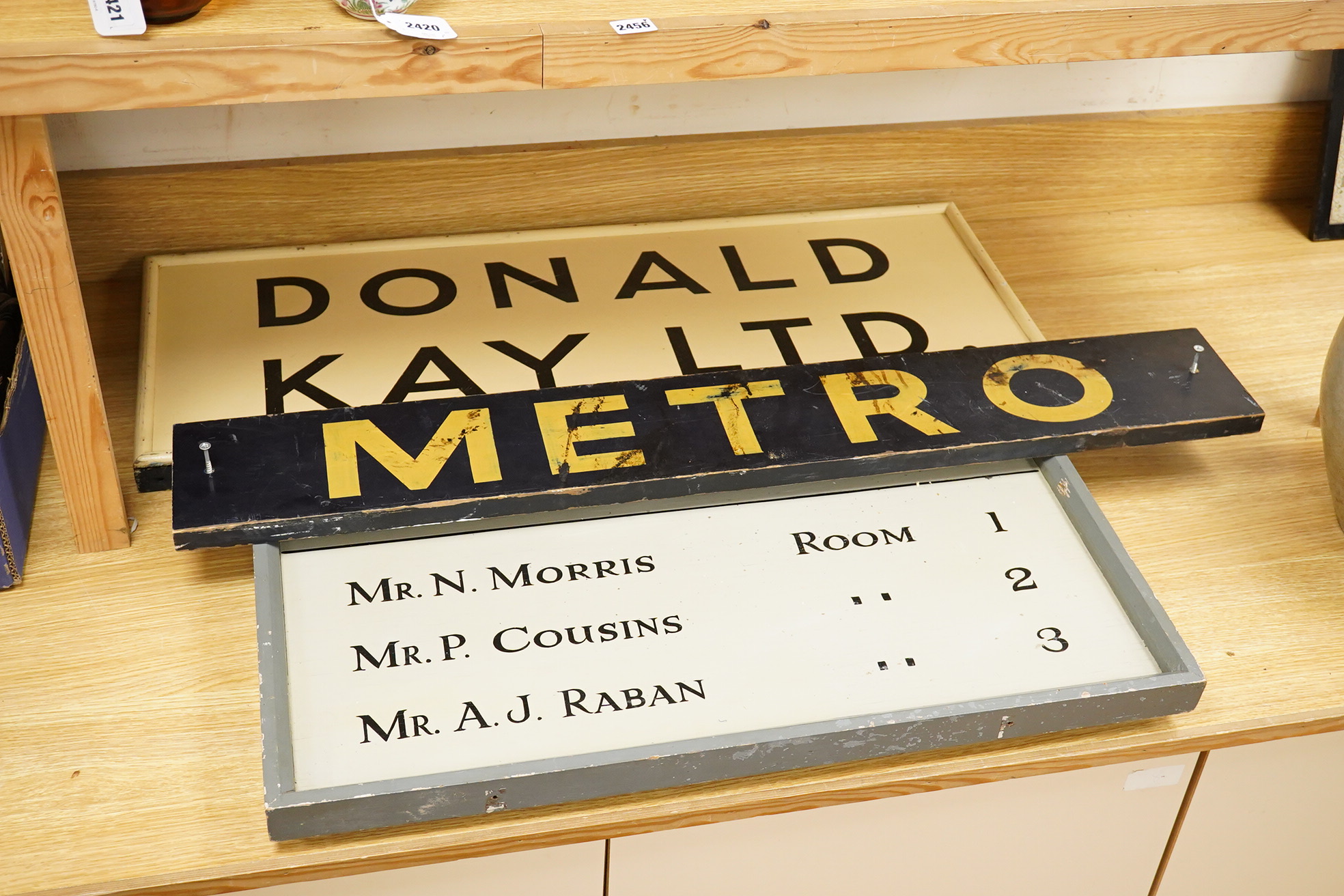 Three wooden signs, one a Metro sign, another First Floor offices, the other Donald Kay Ltd. Metro- 98cm